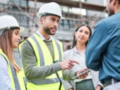 A team of engineers and architects discussing project plan to their client.